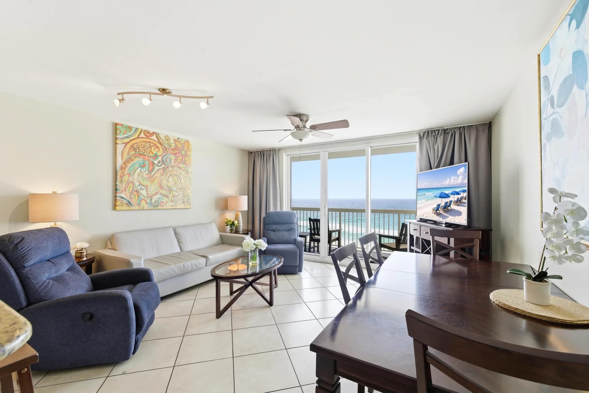 Unit 707 living room, dining table and balcony doors facing the Gulf