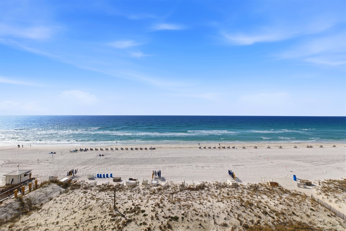 Sugar-white sand and emerald Gulf water at Pelican Beach Resort in Destin